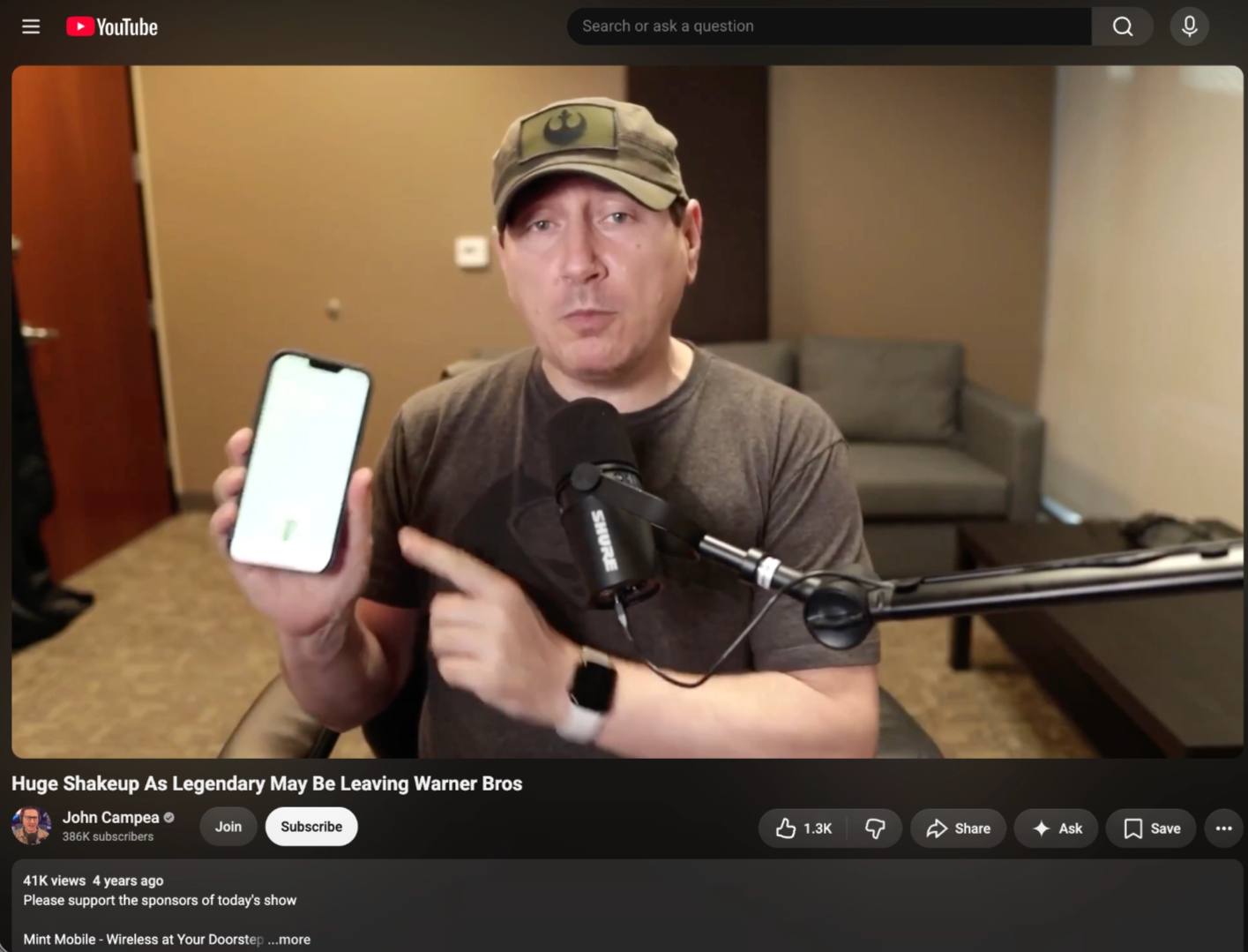 John Campea reading a Mint Mobile sponsor on his daily movie-news show, description reads "Mint Mobile - Wireless at Your Doorstep"